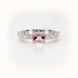 Elegant east-west morganite ring with diamond half-eternity band in 14kt white gold, showcasing a cushion-cut pink stone.