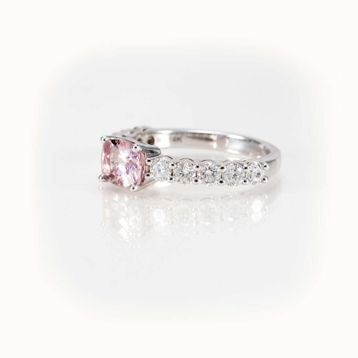 Elegant east-west pink morganite and diamond half-eternity ring in 14kt white gold.