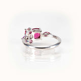 Elegant bespoke design ring featuring pinkish purple garnet and sapphire stones in 14kt white gold.
