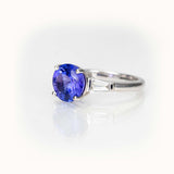 Tanzanite Elegance Ring in 14K white gold with vibrant violet-blue Tanzanite and baguette side stones.