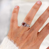 Elegant pink morganite ring with diamond halo on hand, featuring a leaf-inspired curved band in 14K white gold.