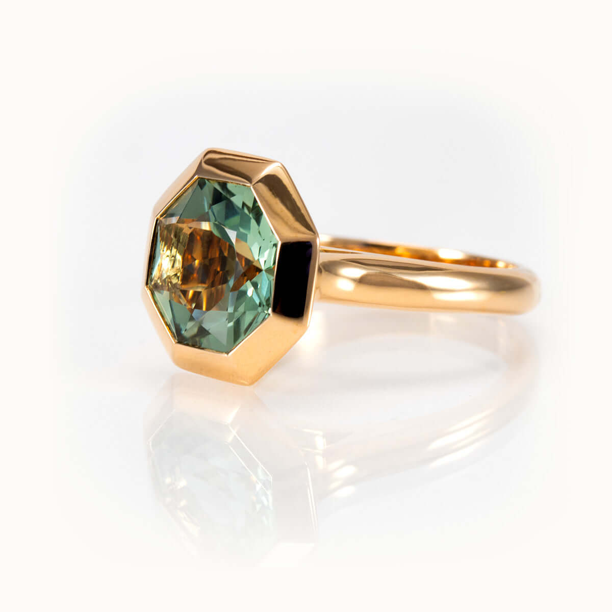 Octagon-cut bespoke prasiolite ring in 14K yellow gold featuring a minty green gemstone for elegant style.